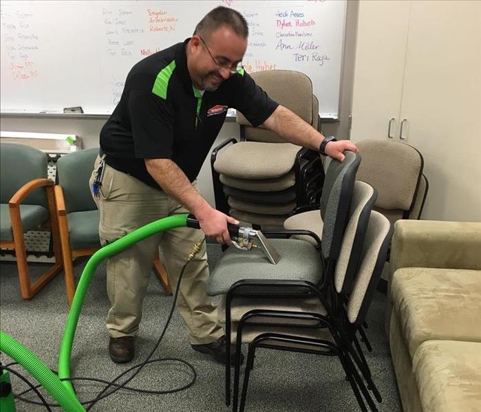 Team member cleaning chairs.