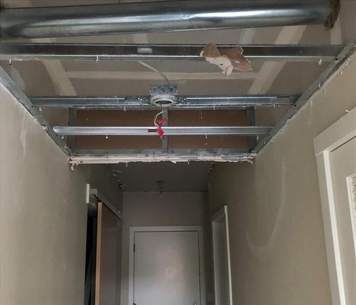 Removed ceiling material in a Seattle business due to a pipe burst