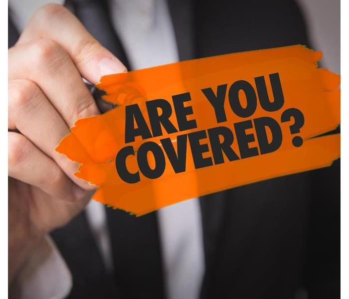 Someone holding a sign that says, Are you covered?