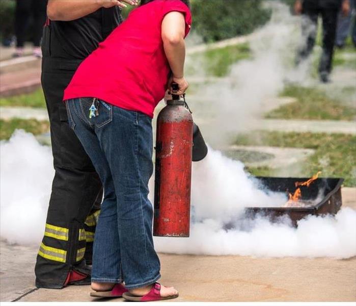 Someone in an extinguisher training
