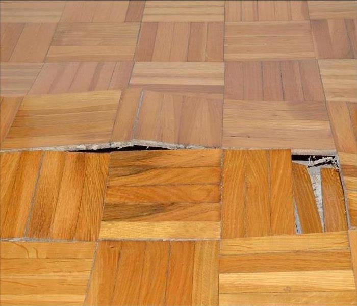 wooden floor damaged by water, swollen wooden floor