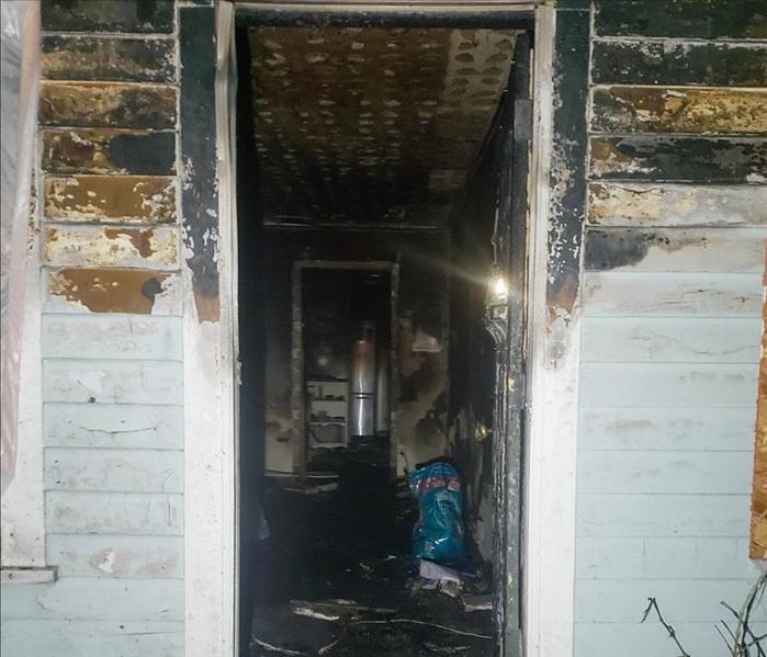 Doorway in a Seattle home with smoke damage on the wall above it